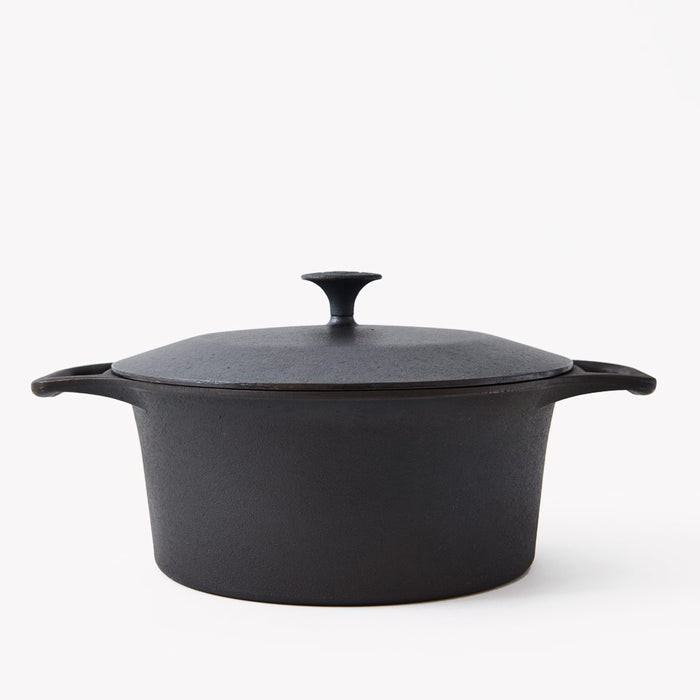 Side view of the No.8 Field Cast Iron Dutch Oven with a domed lid and cast loop handles