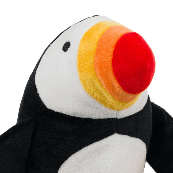 Close up of plush Puffin dog toy with a red, orange and yellow beak on a white back ground.