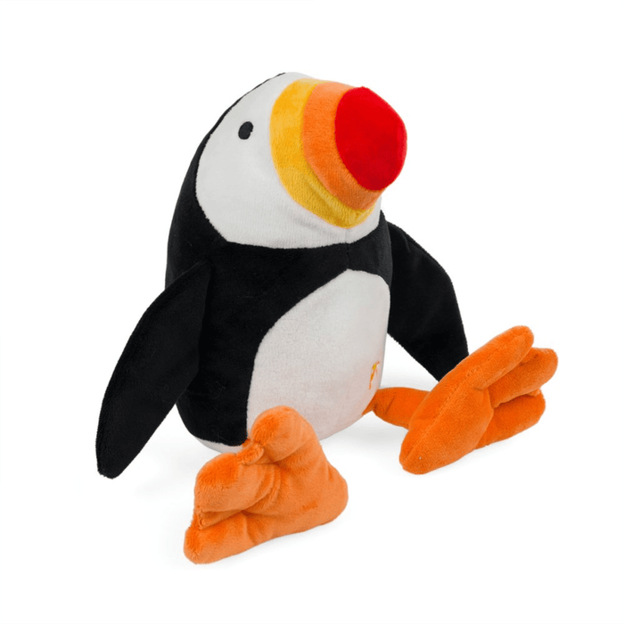 Plush Puffin dog toy with a red, orange and yellow beak and orange feet, sitting on a white back ground.