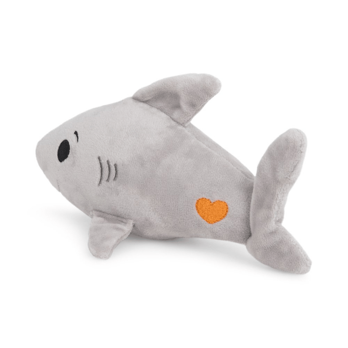 Rear view of grey plush toy shark with orange heart detail on tail on white background.