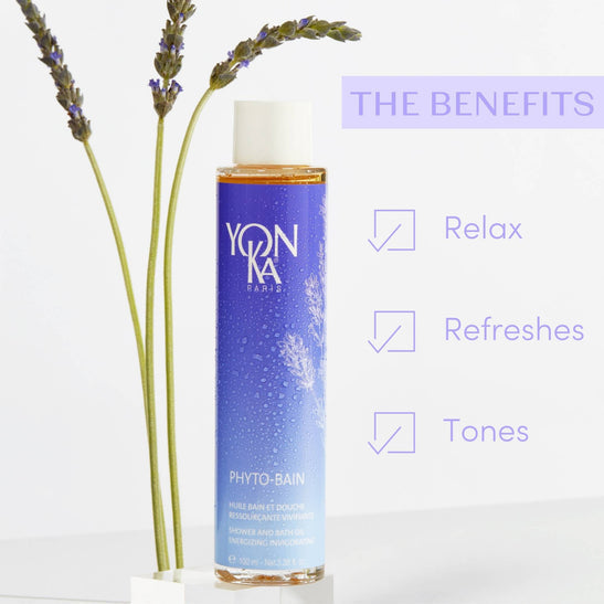 Bottle of Phyto Bain - Invigorating, Relaxing Aromatic Bath I Yon-Ka Paris alongside lavender stems with text highlighting benefits: relax, refreshes, tones, emphasizing skincare and wellness.