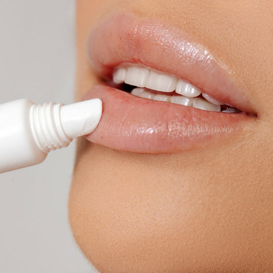 Close-up of a person applying PREMIUM LIP BALM | LipSmart to smooth, hydrated lips, highlighting skincare and lip care for wellness and body care routines.