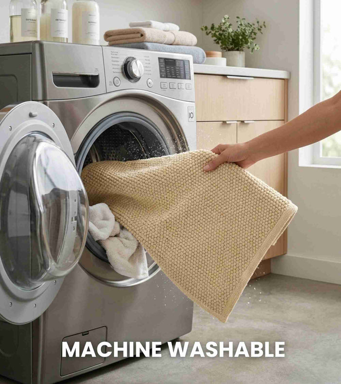 Beige bath mat being folded beside a washing machine, woven rectangular mat