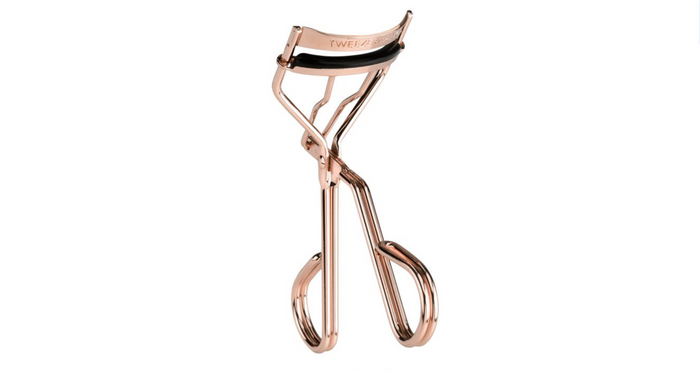 Procurl Lash Curler | Tweezerman in a polished rose gold finish, designed for precise eyelash curling with comfortable grip handles and a cushioned curling pad.