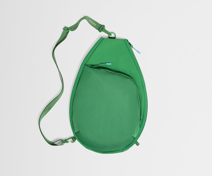 Green crossbody bag on a light gray background