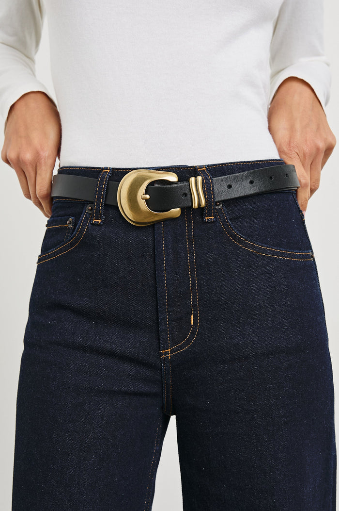 Rodeo Belt with a Black Leather Belt with Belt Loop and a Chunky Gold-Toned Buckle in Brown Gold Colorway - Front View Featured on Model