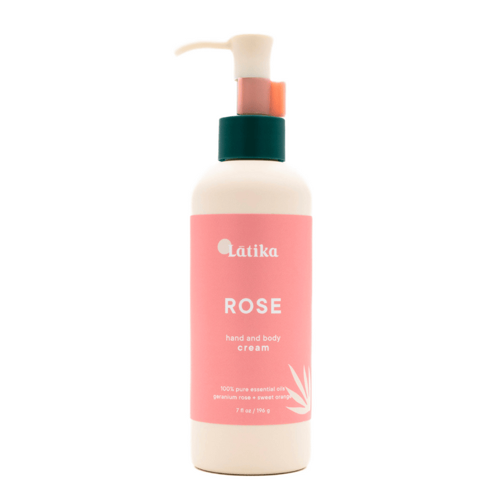Bottle of Rose (wildflower) Hand + Body Cream | Latika with a pink label and pump dispenser for moisturizing skincare and body care.