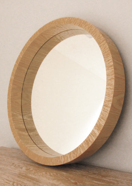 Beautiful, elegant round mirror with a stand out wooden frame.