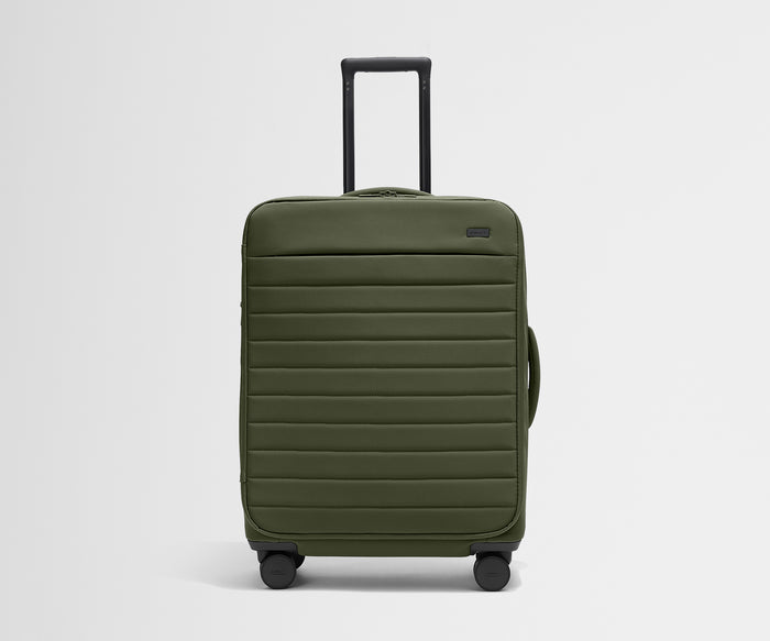 Front product view of The Softside Medium suitcase in Olive Green with raised handle