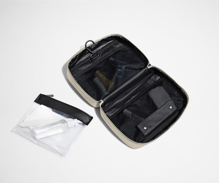 Hanging Toiletry Bag laying flat next to the detachable pouch
