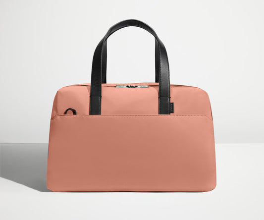 Front view of The Overnight Bag with leather straps up