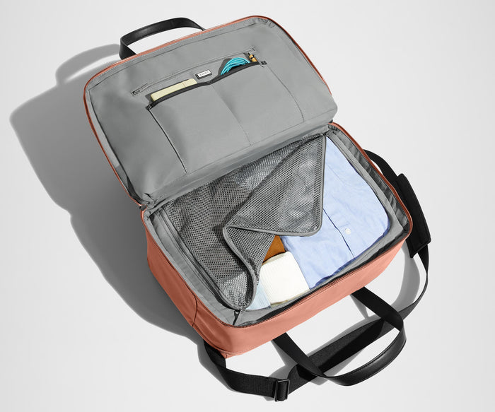 Main interior packed with clothing. Slip pockets packed with a notebook and charging cords
// The Overnight Bag features a detachable padded shoulder strap.