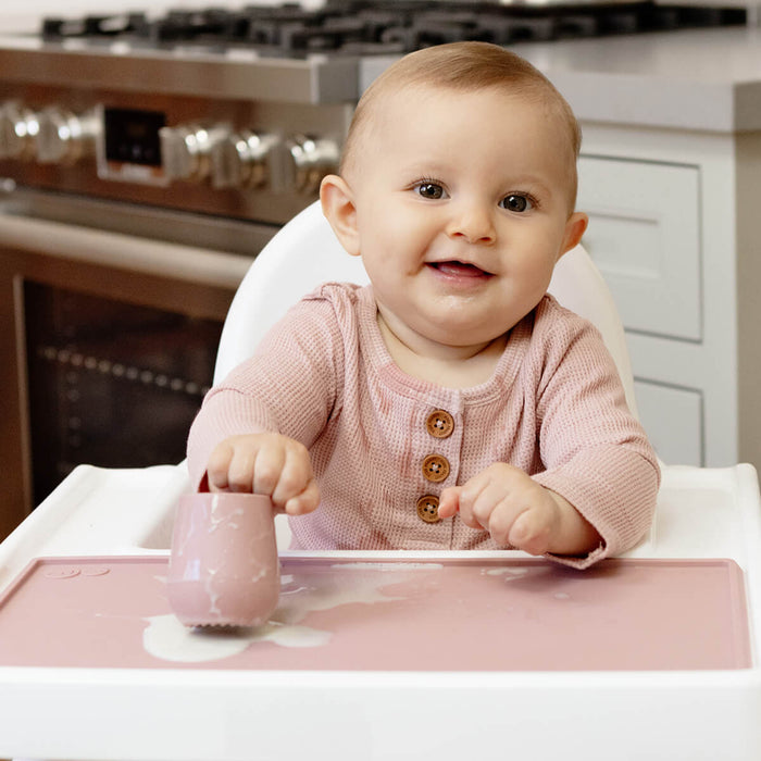 The Tiny Placemat in Blush is a non-slip, silicone placemat that fits on most highchair trays #color_blush