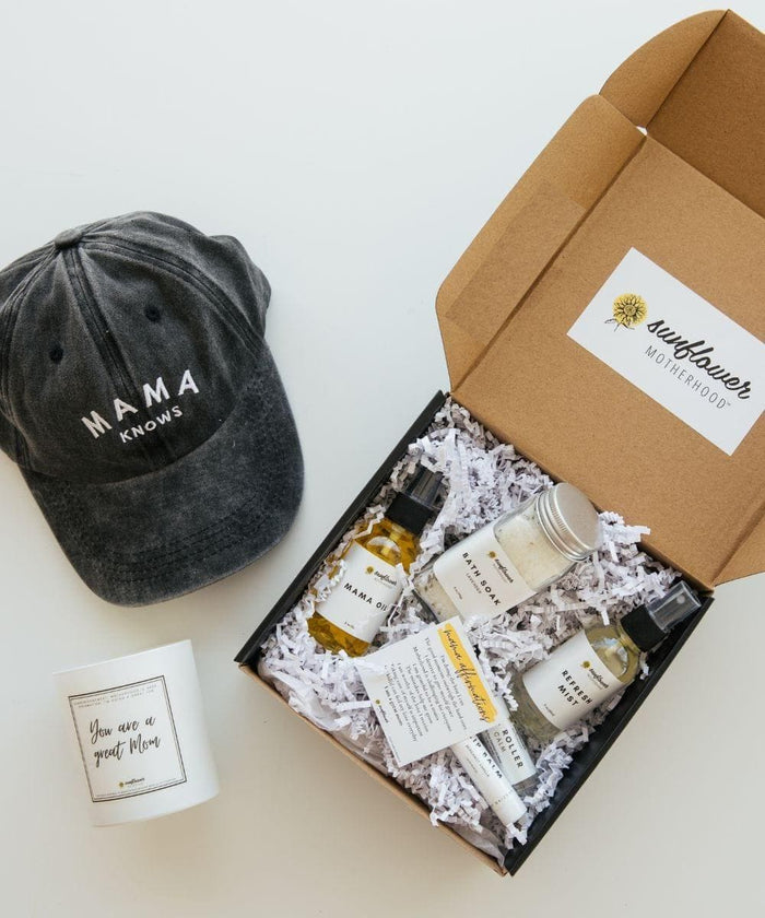 gray hat with word of mama knows and a box of bundle gifts